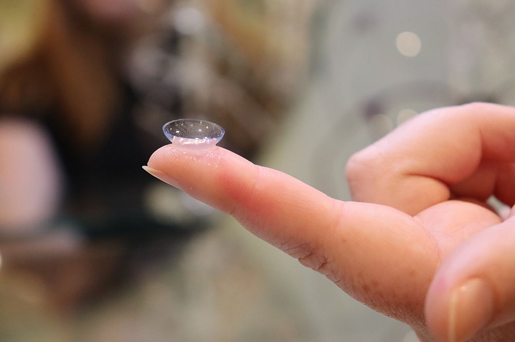 person holding a contact lens