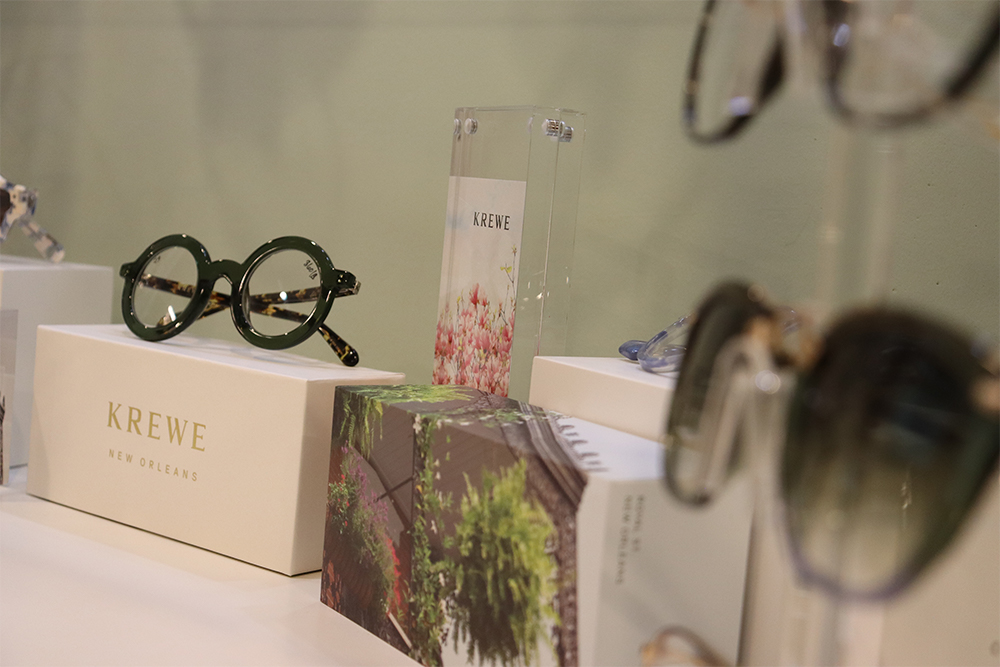 Krewe Eyewear Display – Magnolia Eye Group A stylish display of Krewe New Orleans eyeglasses and sunglasses arranged on branded boxes – Magnolia Eye Group.