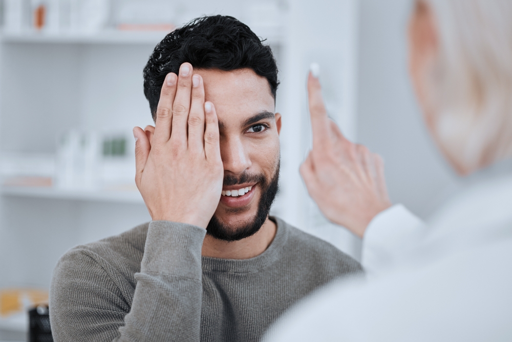 bearded man having an eye examination - Eye Exam in Oxford